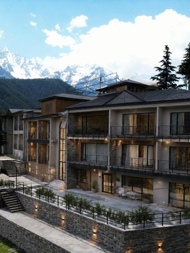 LEORK Hotel Kalam exterior with snow-capped Swat Valley peaks behind it.