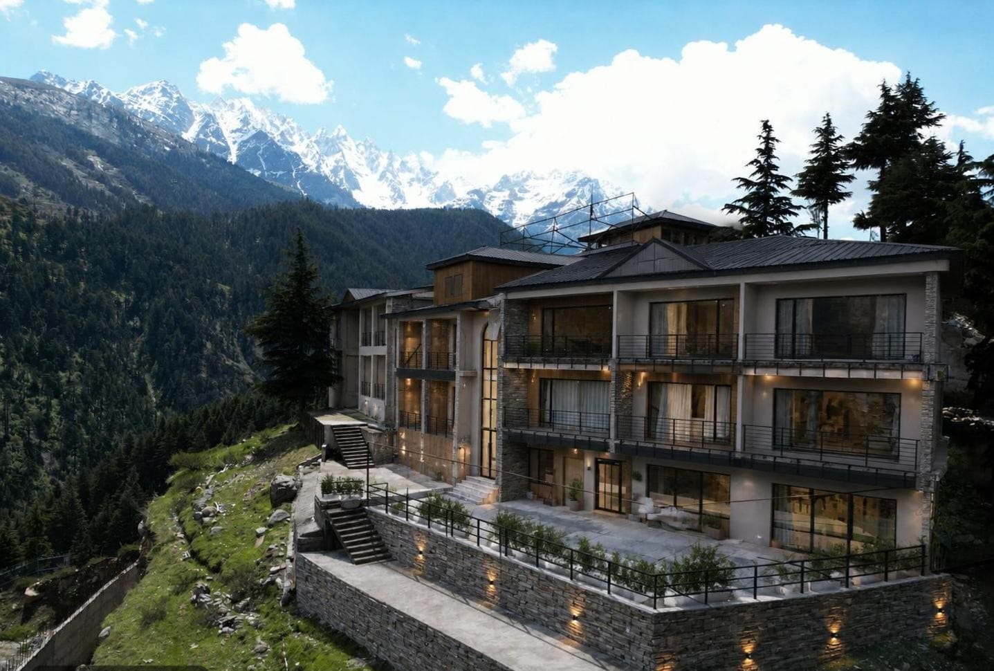 LEORK Hotel Kalam exterior with snow-capped Swat Valley peaks behind it