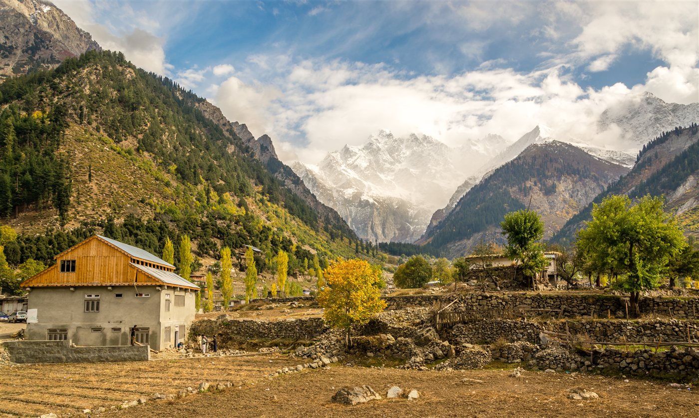 Matiltan village near Kalam with snow-capped peaks behind it