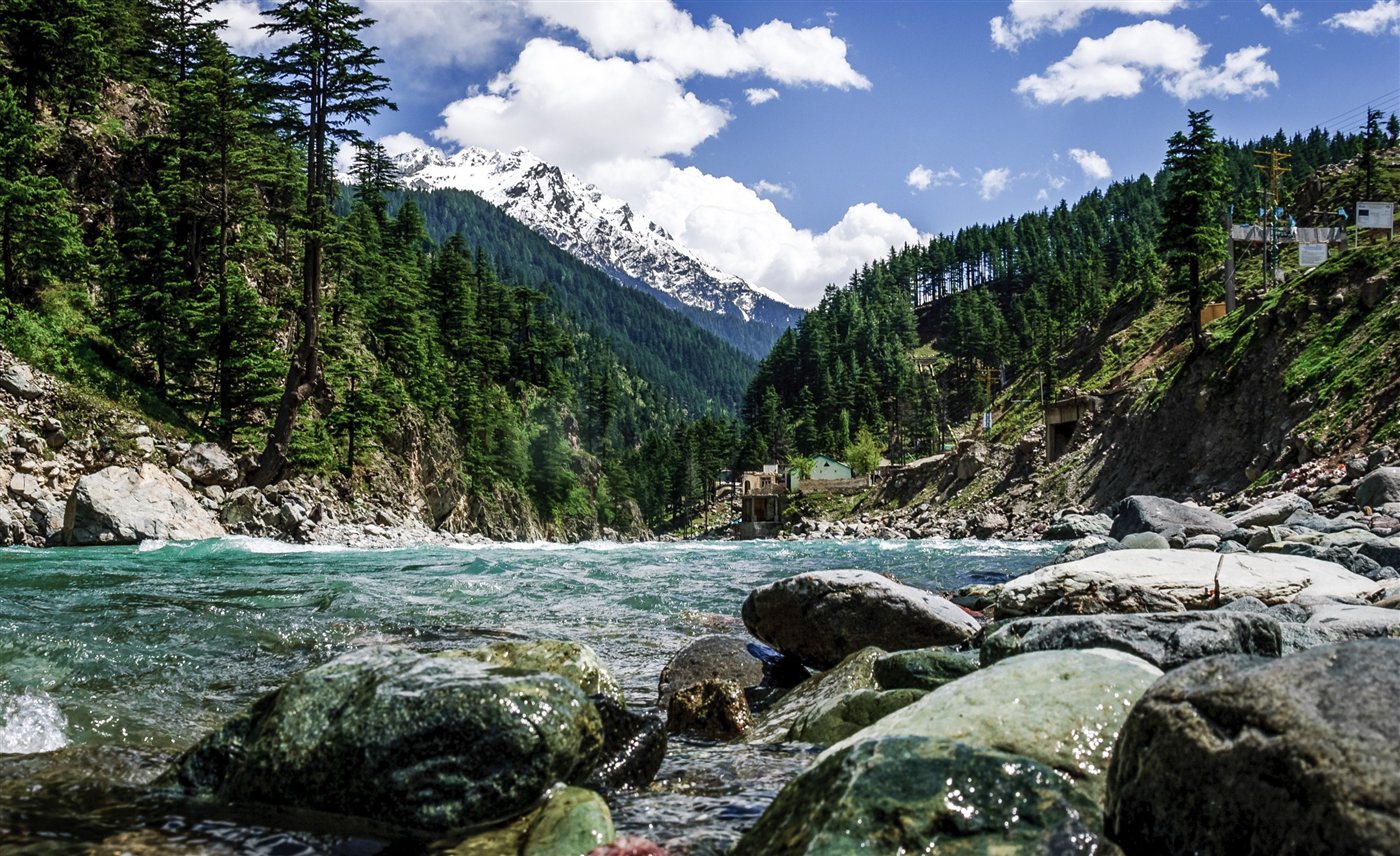 Swat River with snow-capped peaks along the N-95 road to Kalam
