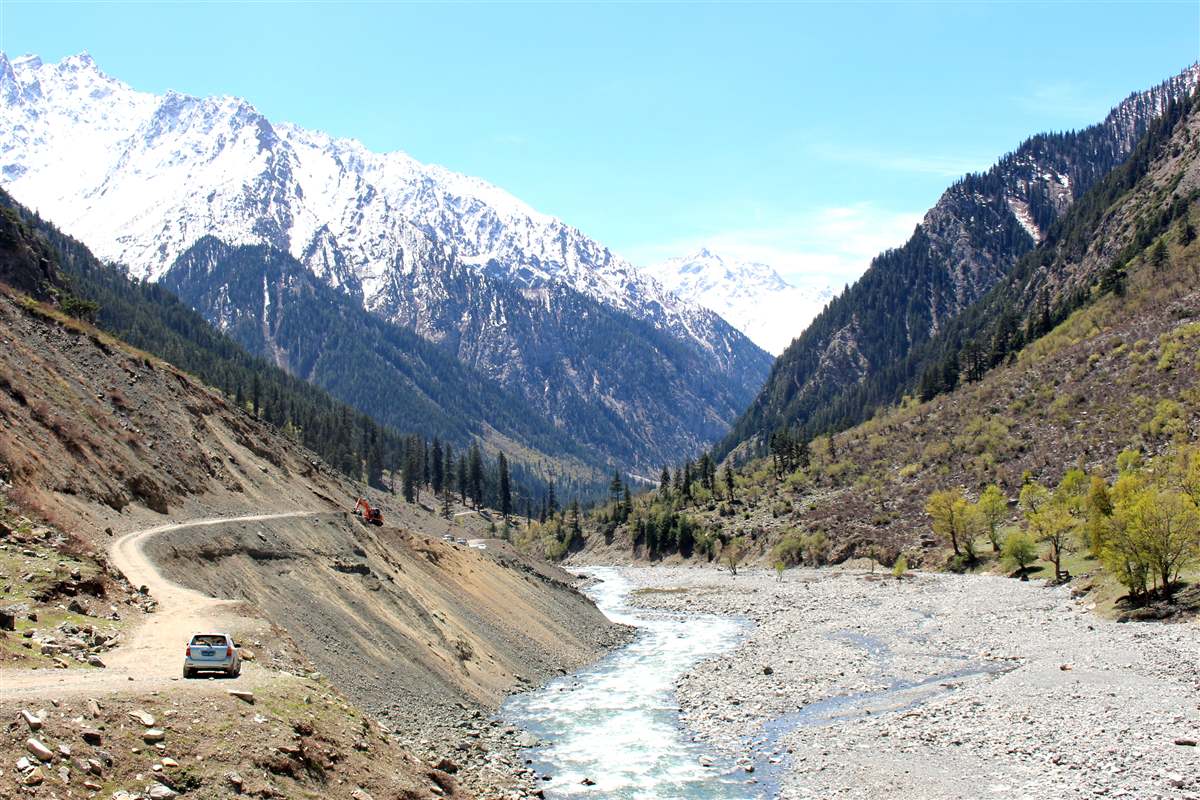 Ushu valley near Kalam in spring, with the river running below snow-covered peaks