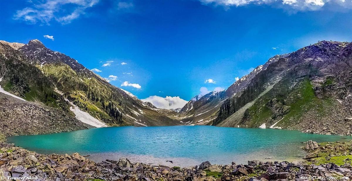 Turquoise water of Kundol Lake ringed by rocky peaks in upper Swat