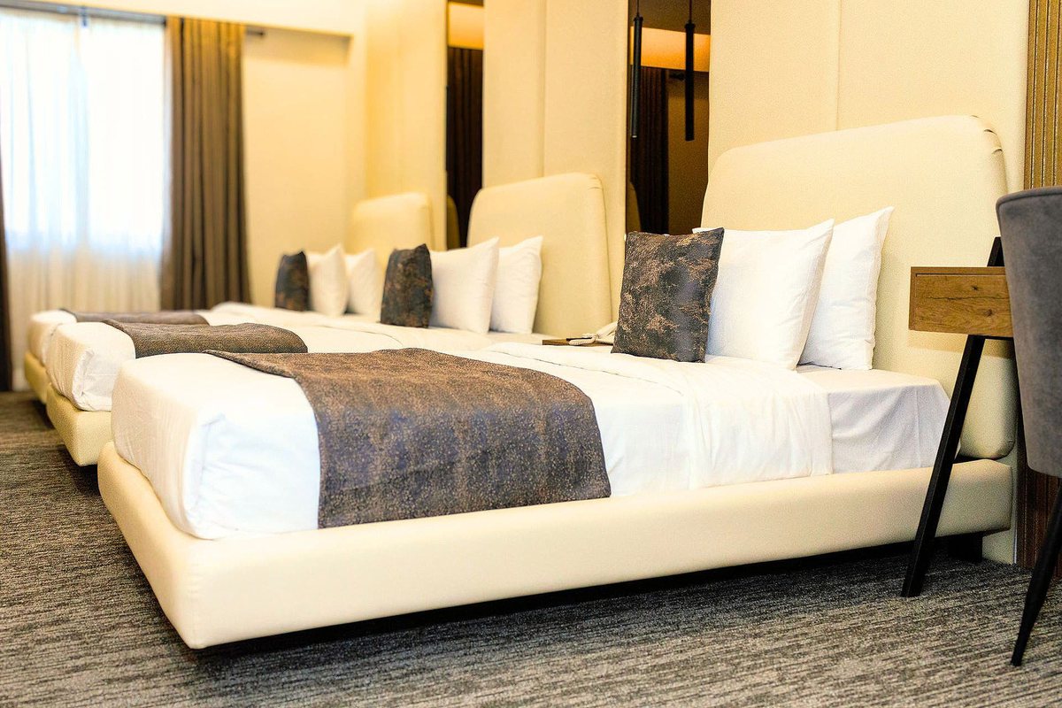 Triple room at LEORK Hotels Rawalpindi with three single beds