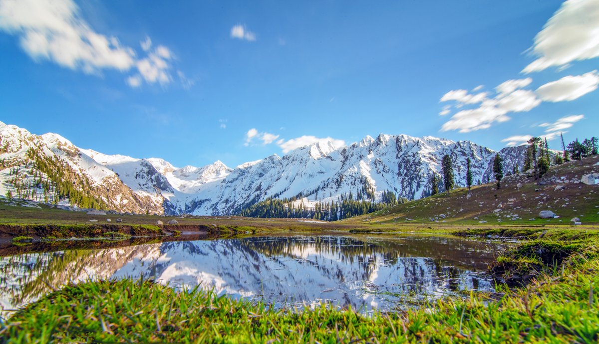 Jahaz Banda meadow pool reflecting snow peaks above Kumrat Valley