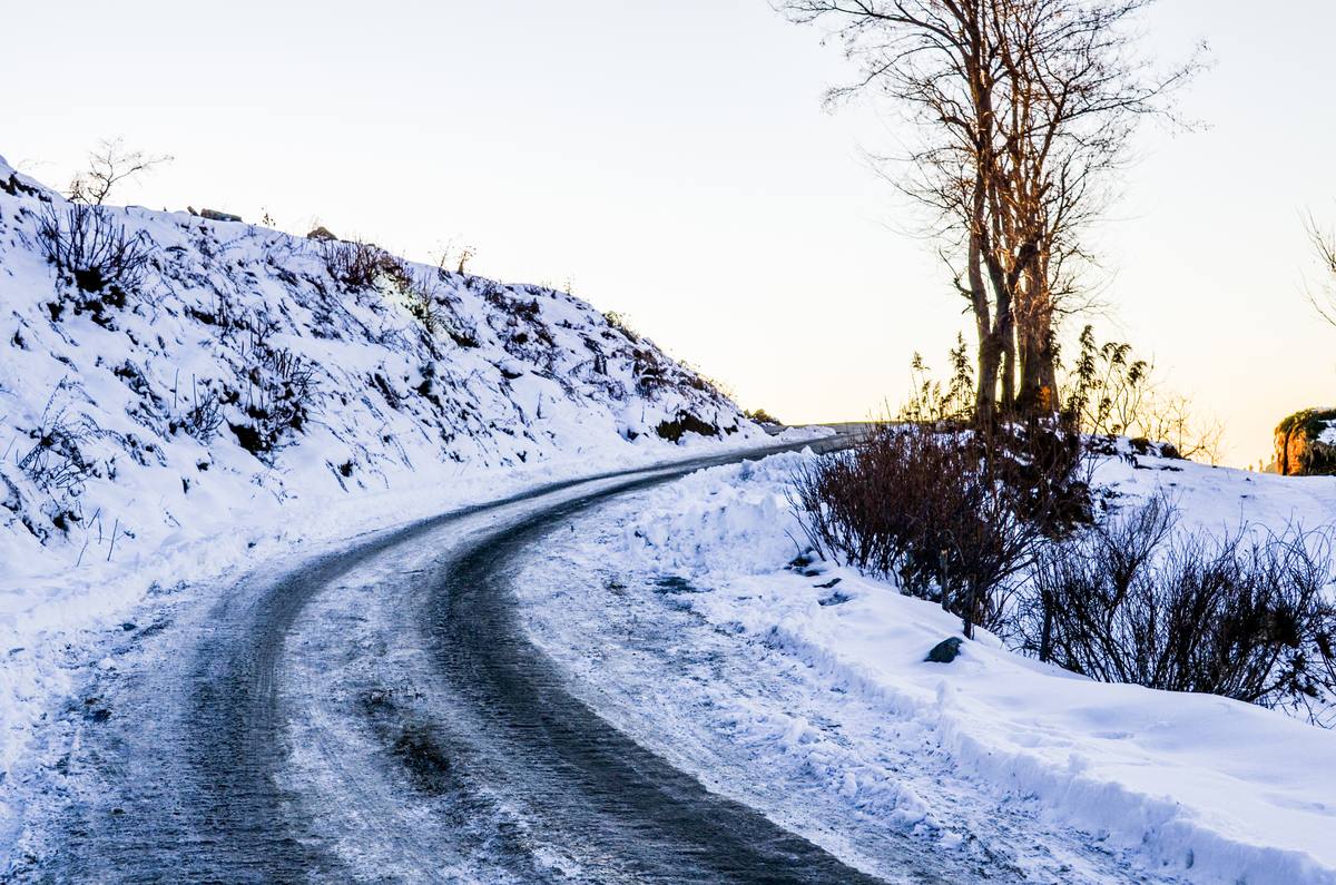 Snow-packed curve on the Malam Jabba road at golden hour