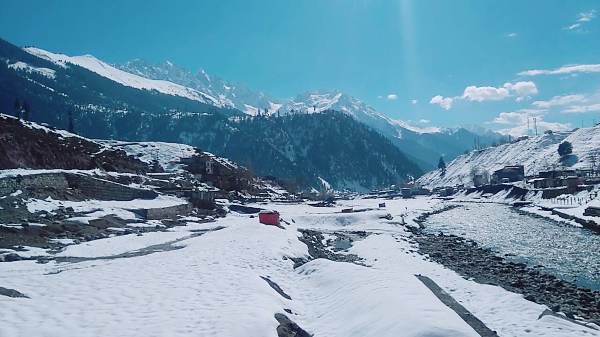 The Swat River running between snowy banks at Kalam