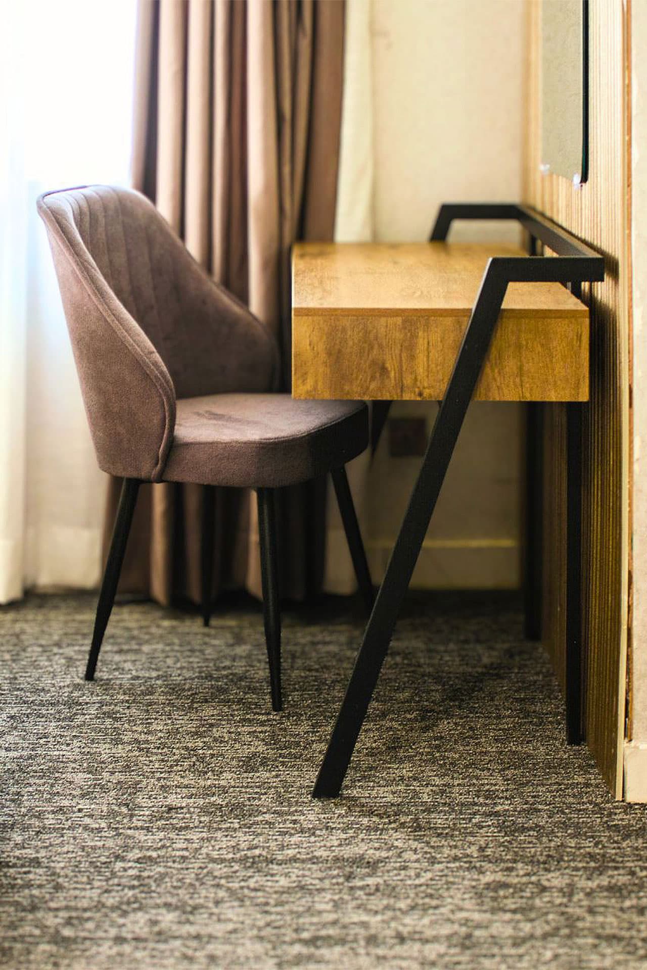 Deluxe King Room with study table, dresser, fridge, and wardrobe at LEORK Hotels Rawalpindi Islamabad