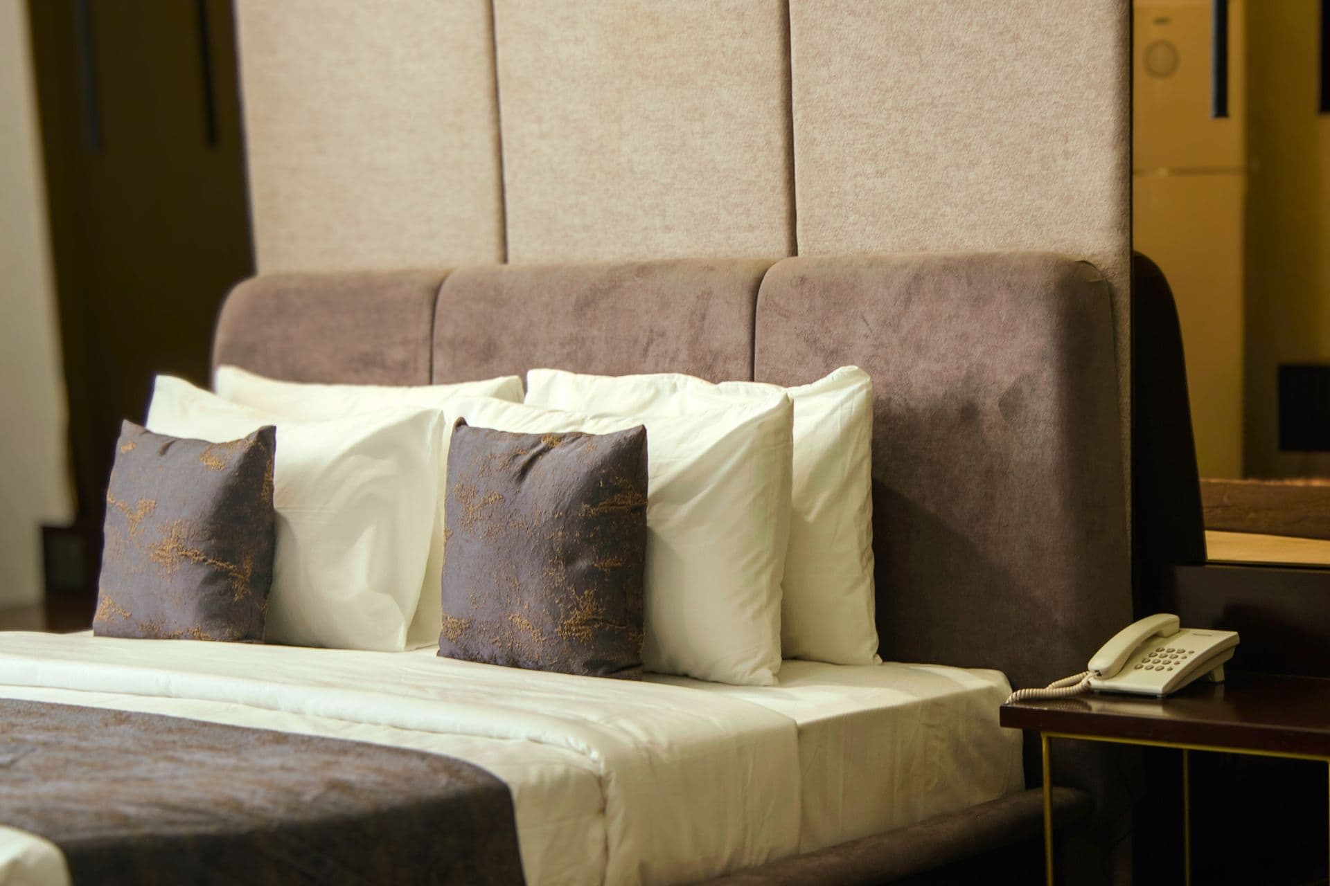 Deluxe King Room close-up of bed with headboard and pillows at LEORK Hotels Rawalpindi Islamabad