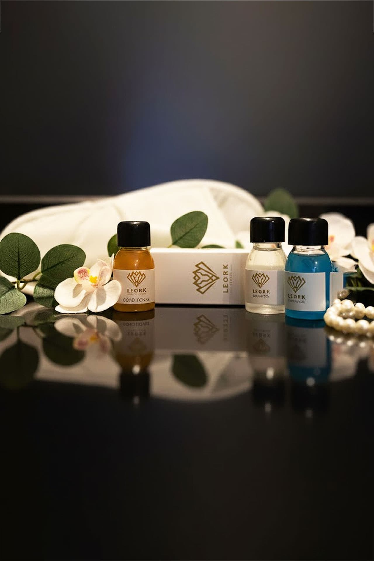 Deluxe King Room amenities mobile view with care package, shampoo, shower gel, and conditioner at LEORK Hotels Rawalpindi Islamabad