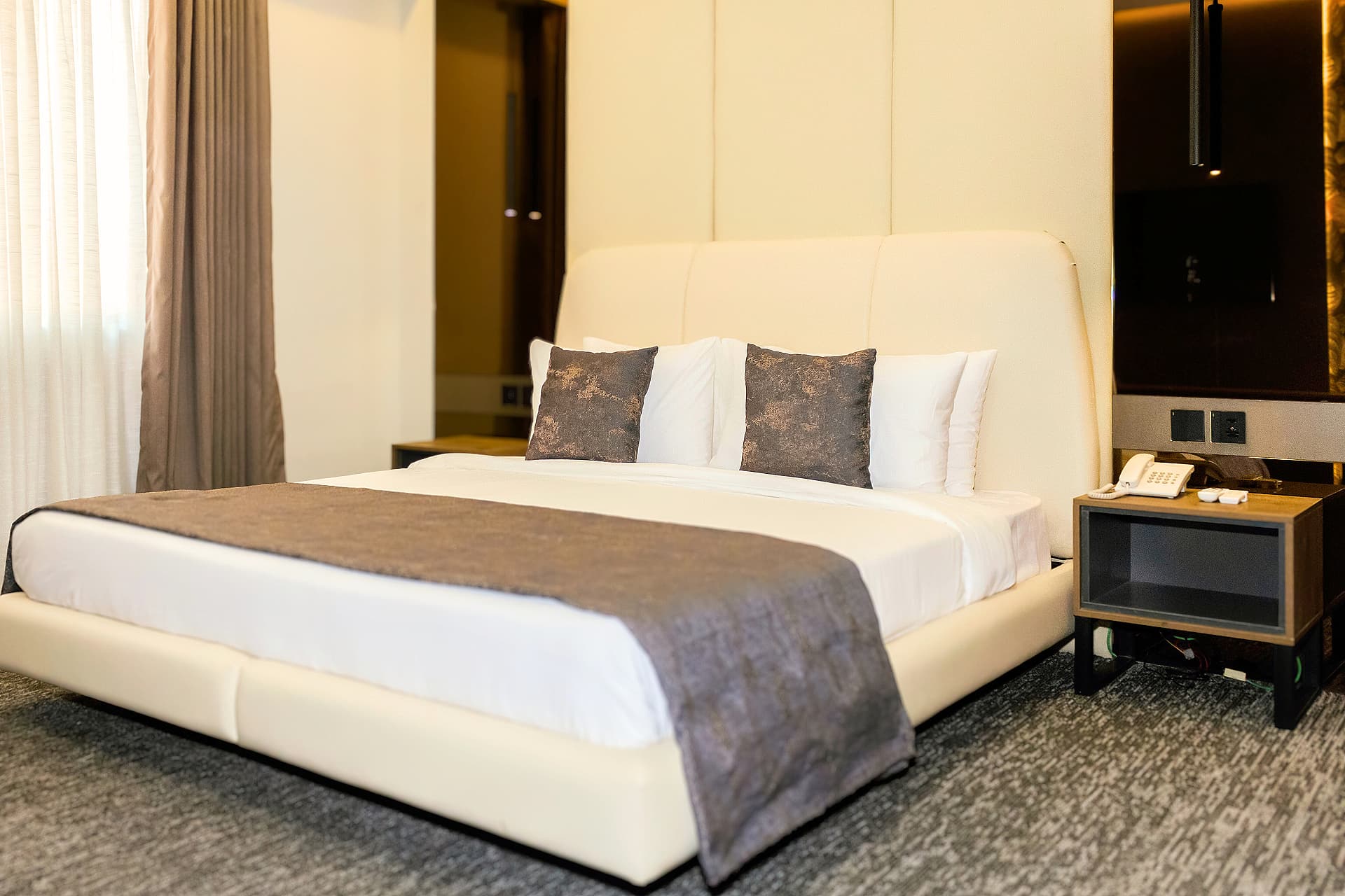 King Room full view with bed, side tables, and headboard at LEORK Hotels Rawalpindi Islamabad