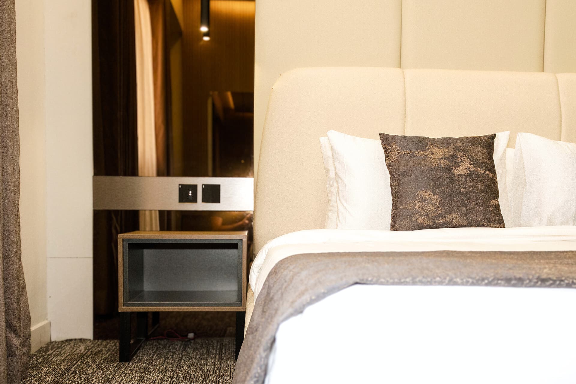 King Room close-up of bed, side table, mirror, and room furniture at LEORK Hotels Rawalpindi Islamabad