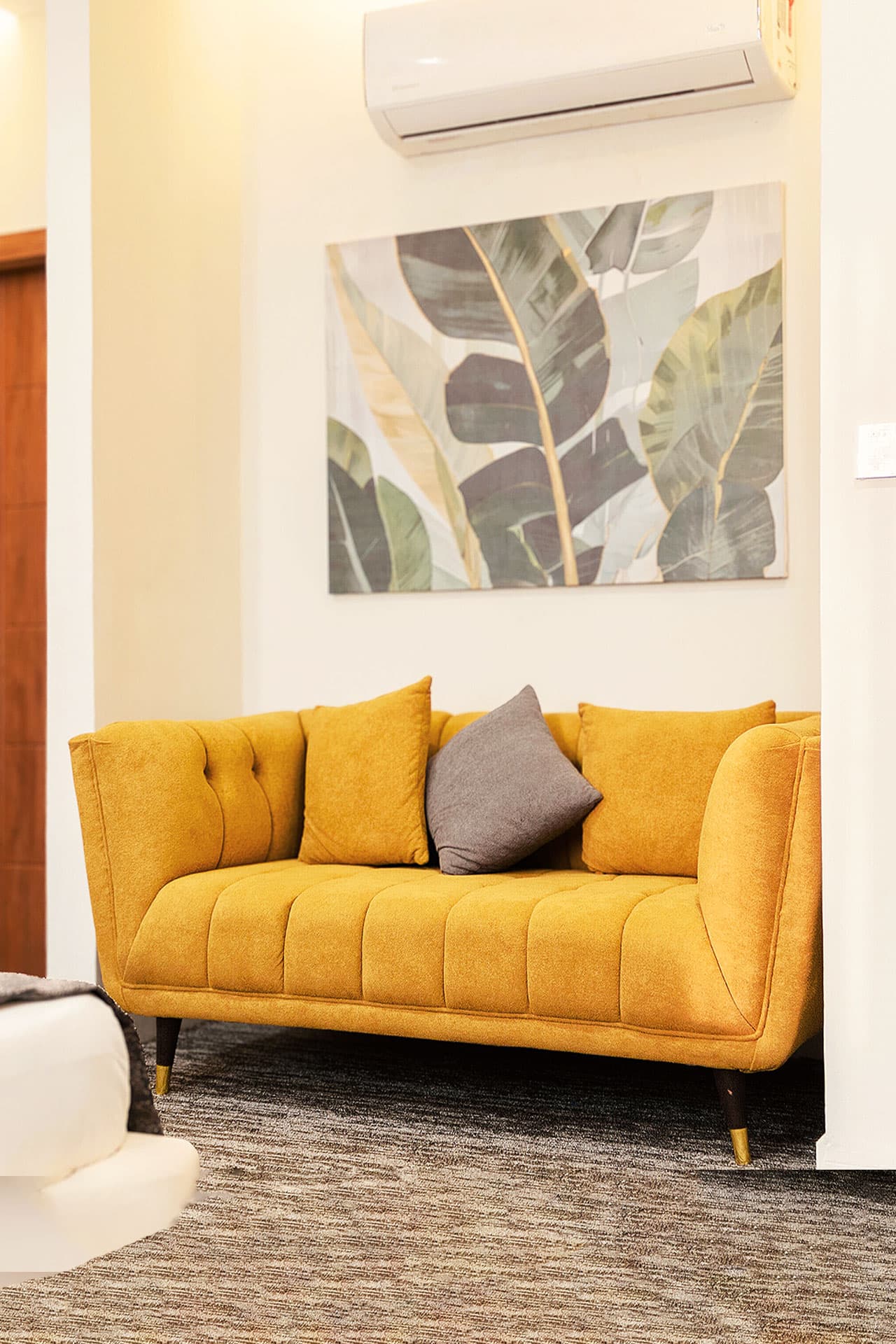 King Room mobile view with sofa, fridge, wardrobe, painting, bathroom, and AC at LEORK Hotels Rawalpindi Islamabad