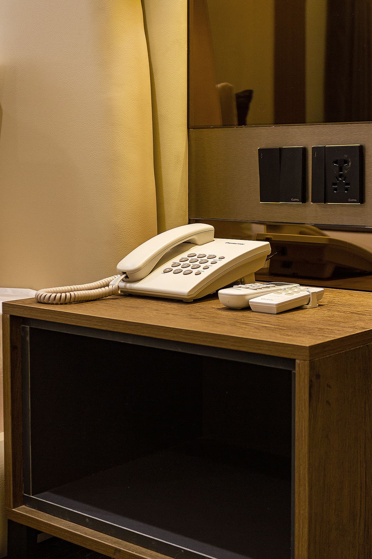 King Room mobile close-up of side table with phone and remotes at LEORK Hotels Rawalpindi Islamabad