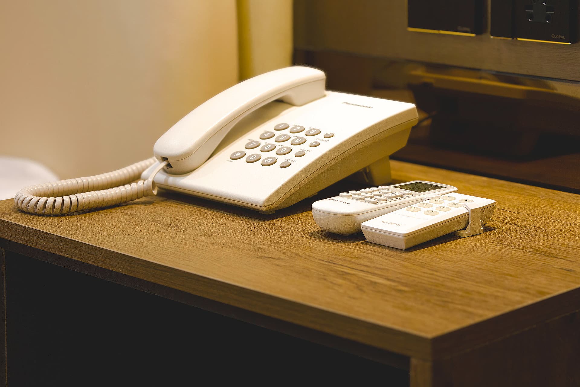 King Room close-up of side table with phone and remotes at LEORK Hotels Rawalpindi Islamabad