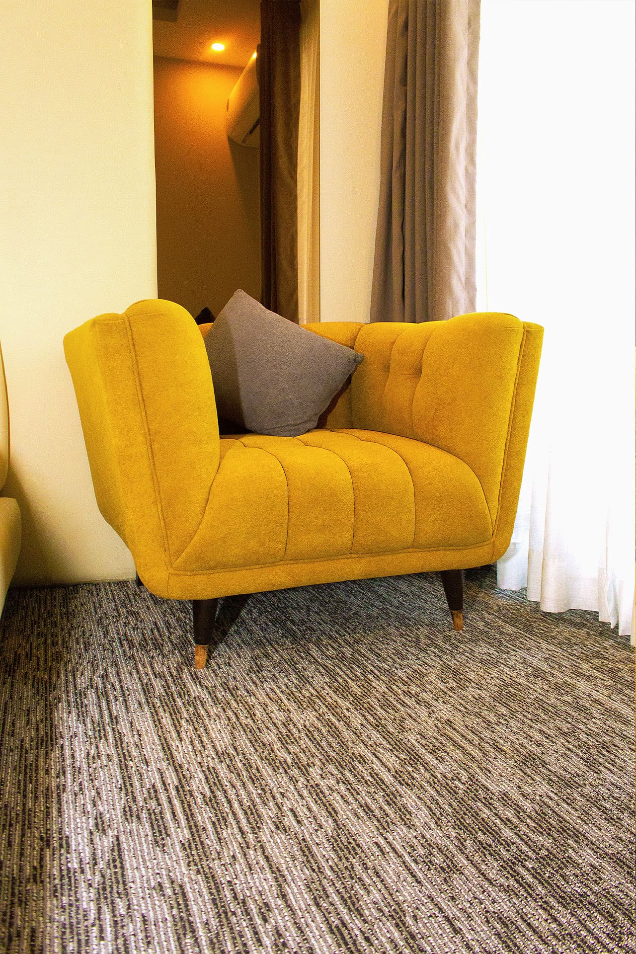 Twin Room mobile close-up with modern sofa, mirror, window, and curtains at LEORK Hotels Rawalpindi Islamabad