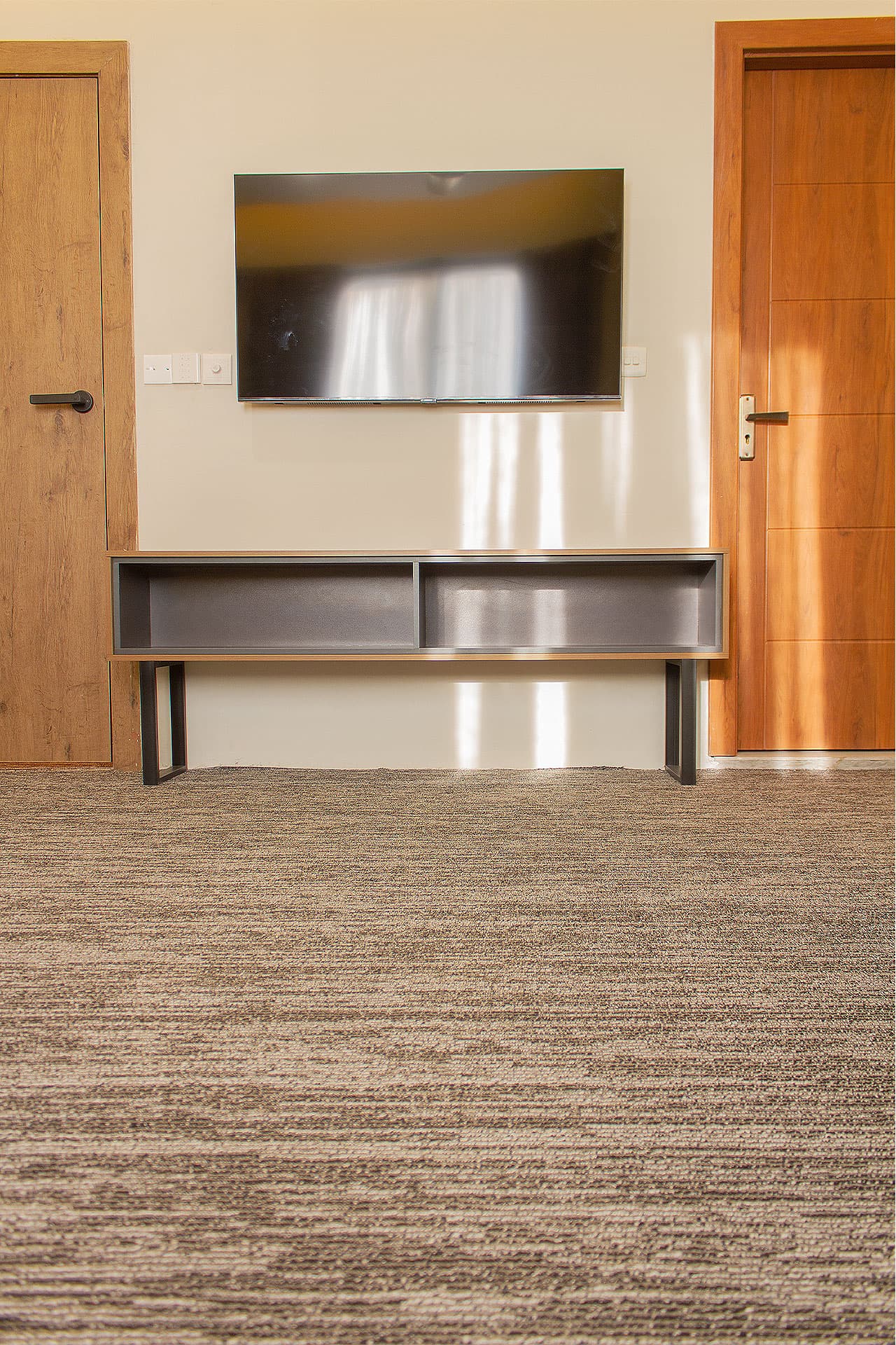 Twin Room mobile view with media wall, bathroom, study table, wardrobe, fridge, bed, TV, and AC at LEORK Hotels Rawalpindi Islamabad